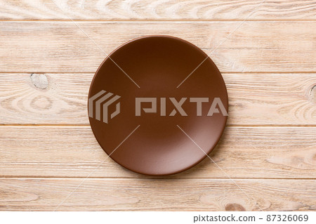 Top view of empty plate on wooden background. Empty space for your design 87326069