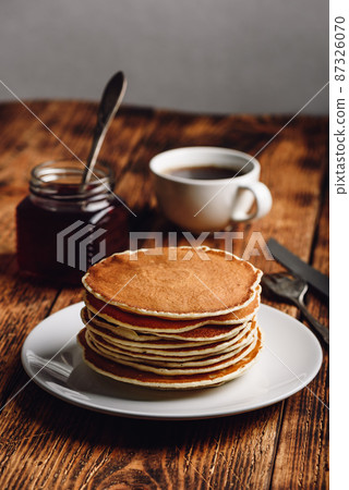 Stack of pancakes on white plate 87326070