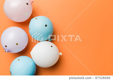 Background with fastive air balloons of round shape and confetti, multicoloured top view. Birthday party background 87326088