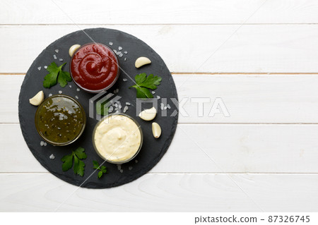 Many different sauces and herbs on table, flat lay top view. sauces on plate, healthy concept Many different sauces and herbs on table, flat lay top view. sauces on plate, healthy concept 87326745