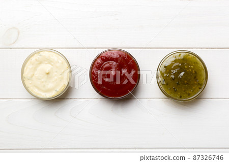 Different types of sauces in bowls on a colored Board . Top view. various sauces copy space 87326746