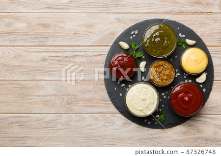 Many different sauces and herbs on table, flat lay top view. sauces on plate, healthy concept 87326748