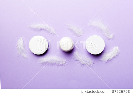 Spa cosmetic product, cream jar, branding mock up, top view with feathers background. Flat lay 87326798