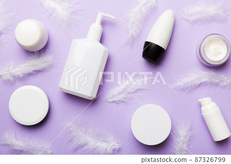 Spa cosmetic product, cream jar, branding mock up, top view with feathers background. Flat lay 87326799