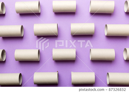 Empty toilet paper roll on colored background. Recyclable paper tube with metal plug end made of kraft paper or cardboard Empty toilet paper roll on colored background. Recyclable paper tube with metal plug end made of kraft paper or cardboard 87326832