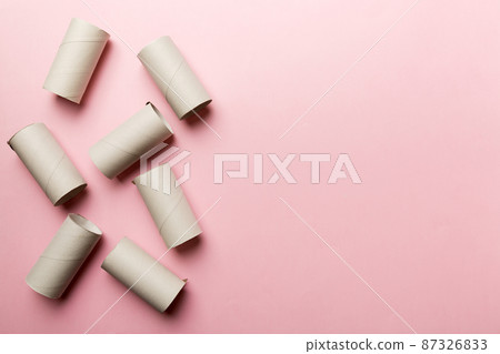 Flat lay composition with empty toilet paper rolls and space for text on color background. Recyclable paper tube with metal plug end made of kraft paper or cardboard Flat lay composition with empty toilet paper rolls and space for text on color background. Recyclable paper tube with metal plug end made of kraft paper or cardboard 87326833