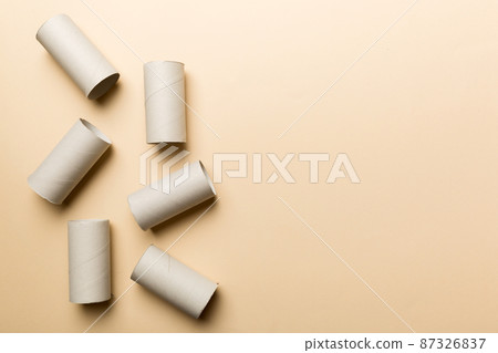 Flat lay composition with empty toilet paper rolls and space for text on color background. Recyclable paper tube with metal plug end made of kraft paper or cardboard Flat lay composition with empty toilet paper rolls and space for text on color background. Recyclable paper tube with metal plug end made of kraft paper or cardboard 87326837