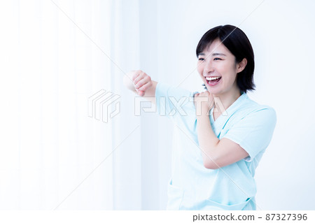 A caregiver woman doing recreational and fun gymnastics A caregiver woman doing recreational and fun gymnastics 87327396