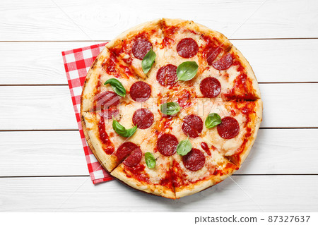 Hot delicious pepperoni pizza on white wooden table, top view Hot delicious pepperoni pizza on white wooden table, top view 87327637