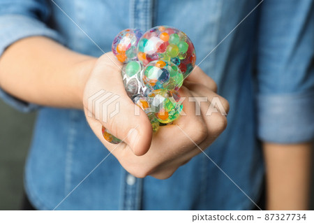Woman squeezing colorful slime, closeup. Antistress toy Woman squeezing colorful slime, closeup. Antistress toy 87327734
