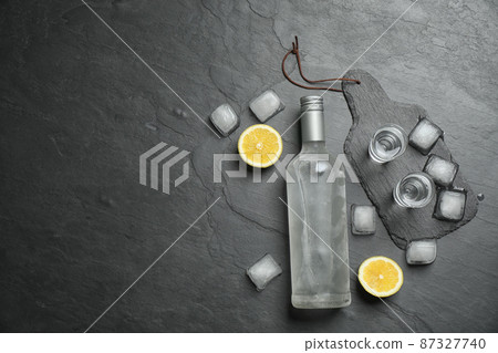 Flat lay composition with cold Russian vodka on black table. Space for text 87327740