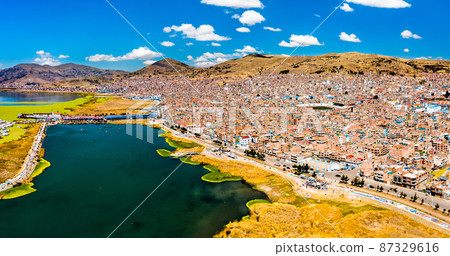 View of Puno with Lake Titicaca in Peru 87329616