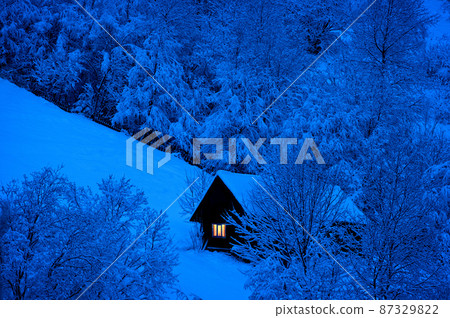 night is coming, old house covered with snow on the background of the forest night is coming, old house covered with snow on the background of the forest 87329822