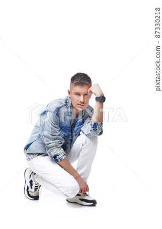 handsome young man in Jean jacket on white background 87330218