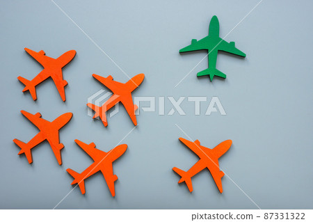 Orange planes and green one. Individuality and find your own way concept. Orange planes and green one. Individuality and find your own way concept. 87331322