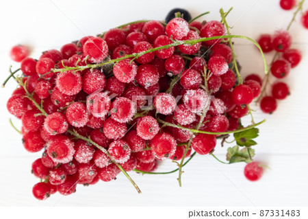 Frozen red and black currants in on a light background . The concept of preparing products for use in the future. Frozen red and black currants in on a light background . The concept of preparing products for use in the future. 87331483