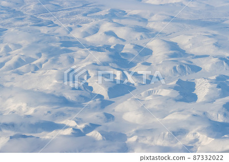 Aerial view of snow-capped mountains 87332022