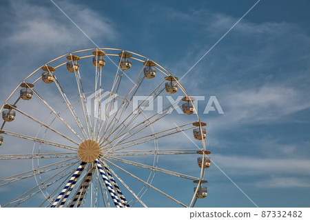 Ferris wheel against blue sky. Ferris wheel against blue sky. 87332482
