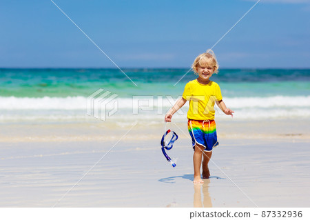 Child snorkeling on tropical beach. Kids snorkel. 87332936