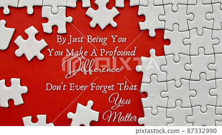 Top view of motivational quote on red cover with jigsaw puzzle missing pieces background. Motivational and inspirational concept. Top view of motivational quote on red cover with jigsaw puzzle missing pieces background. Motivational and inspirational concept. 87332990