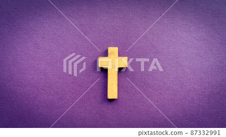 Cross on purple color cover. Christianity and religious concept 87332991