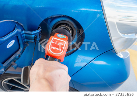 A photo of refueling at a self-service gas station in Japan. Image of a car running on gasoline. A photo of refueling at a self-service gas station in Japan. Image of a car running on gasoline. 87333656
