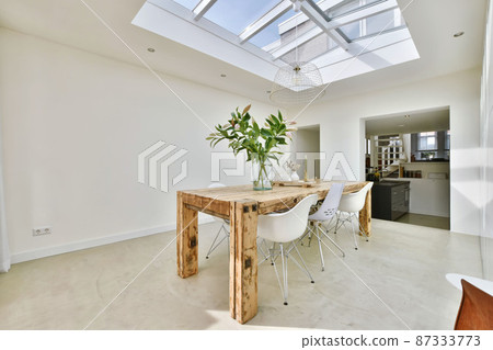 Elite dining area with glass ceiling and white walls Elite dining area with glass ceiling and white walls 87333773