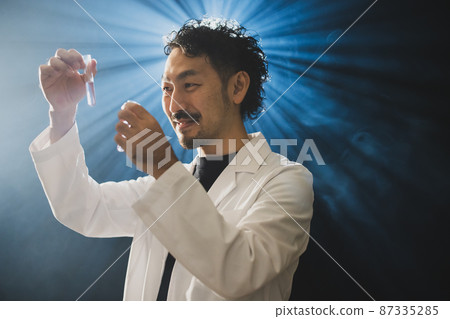 A bearded man in a white coat that looks like a mad scientist 87335285