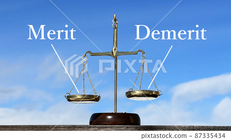Merit and Demerit Lettered Gold Balance_Blue Sky Background 87335434