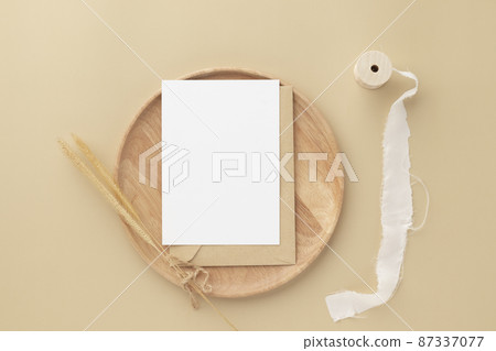 Blank greeting card invitation Mockup on Brown envelope with Dried bunny tails grass on beige background, Minimal table workplace composition, flat lay, mockup Blank greeting card invitation Mockup on Brown envelope with Dried bunny tails grass on beige background, Minimal table workplace composition, flat lay, mockup 87337077