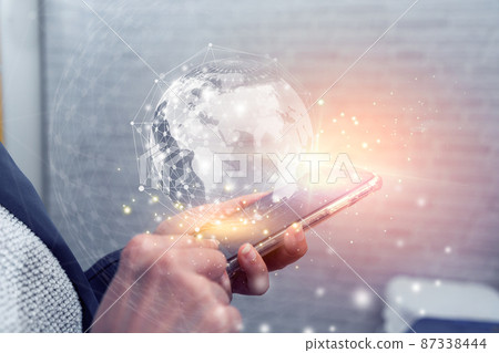Businesswoman hand holding tablet with glowing globe interface. Global futuristic innovation concept. 87338444