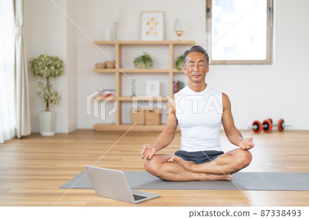 Senior man doing online yoga 87338493