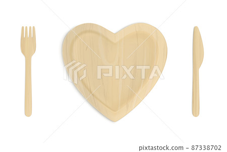 Wooden heart plate with fork and knife top view 87338702