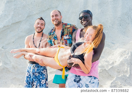 three multiracial young men with a girl in their arms three multiracial young men with a girl in their arms 87339882