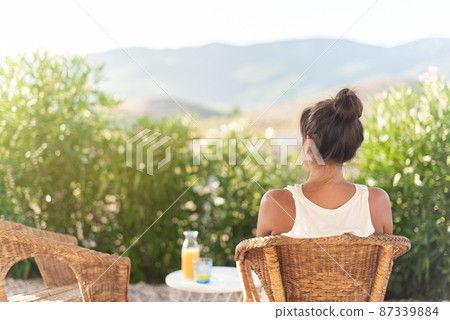 Rear view of an adult woman in rural home Rear view of an adult woman in rural home 87339884