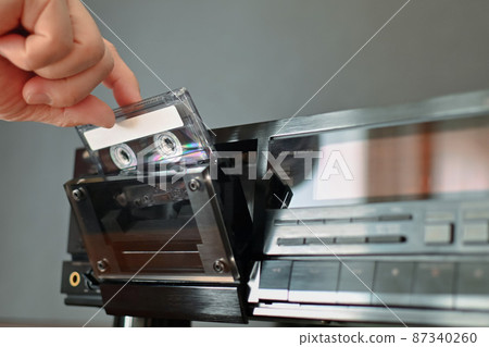 Hand to take out the cassette tape 87340260