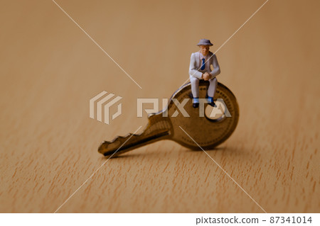 Businessman sitting on the key Businessman sitting on the key 87341014