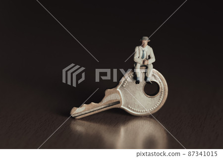 Businessman sitting on the key Businessman sitting on the key 87341015