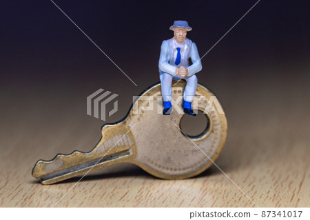 Businessman sitting on the key Businessman sitting on the key 87341017