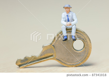 Businessman sitting on the key 87341018