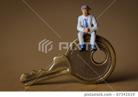 Businessman sitting on the key Businessman sitting on the key 87341019