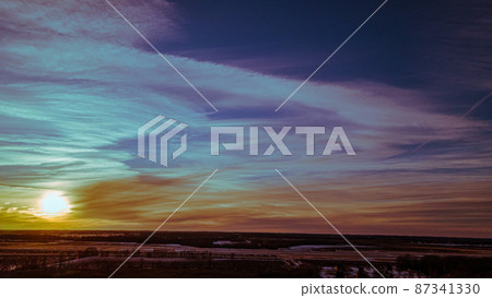 Vibrant beautiful winter sunset with angelic clouds Vibrant beautiful winter sunset with angelic clouds 87341330