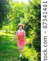 Red haired girl on a sunny day having fun in a park. 87341481