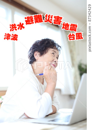 Image of senior women worried about disaster prevention Image of senior women worried about disaster prevention 87342429