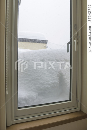Windows filled with heavy snow Windows filled with heavy snow 87342742