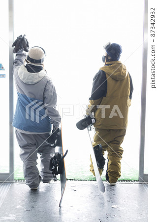 Snowboard girls getting ready and heading to the slopes 87342932