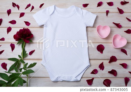 White baby short sleeve bodysuit mockup with pink hearts two pink hearts, maroon peony and petals. White baby short sleeve bodysuit mockup with pink hearts two pink hearts, maroon peony and petals. 87343005