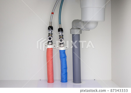 Image of red and blue water pipes under the sink 87343333