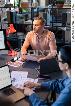 Business people sitting at the table and working with financial documents, they analyzing and building the strategy at meeting at office Business people sitting at the table and working with financial documents, they analyzing and building the strategy at meeting at office 87344262