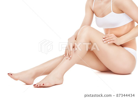 Studio shot of young well shaped woman with a beautiful body sitting on white background 87344434